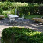a-white-table-and-chairs-in-a-park-setting