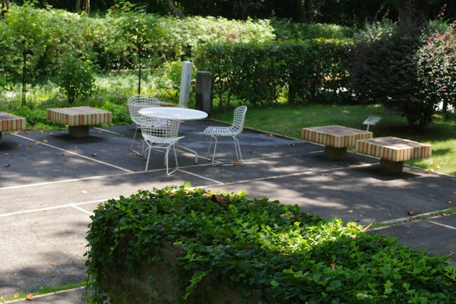 a-white-table-and-chairs-in-a-park-setting